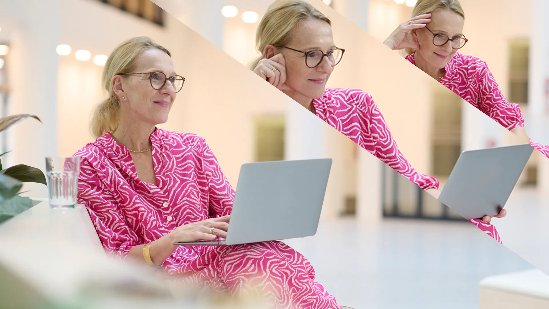 Eine Frau in einem pinken Kleid arbeitet an einem Laptop in einer modernen Büroumgebung.