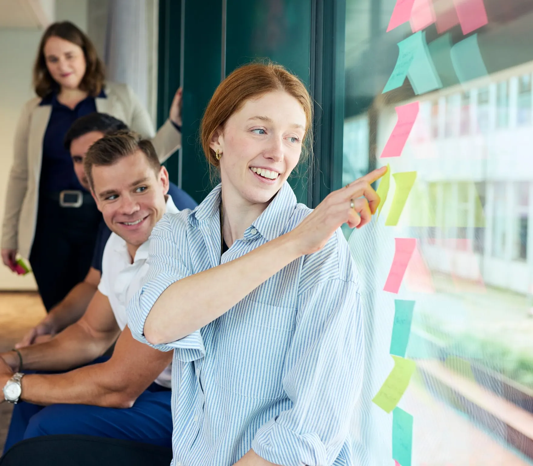 Team having a casual chat in a bright, modern office lounge at Computacenter AG.