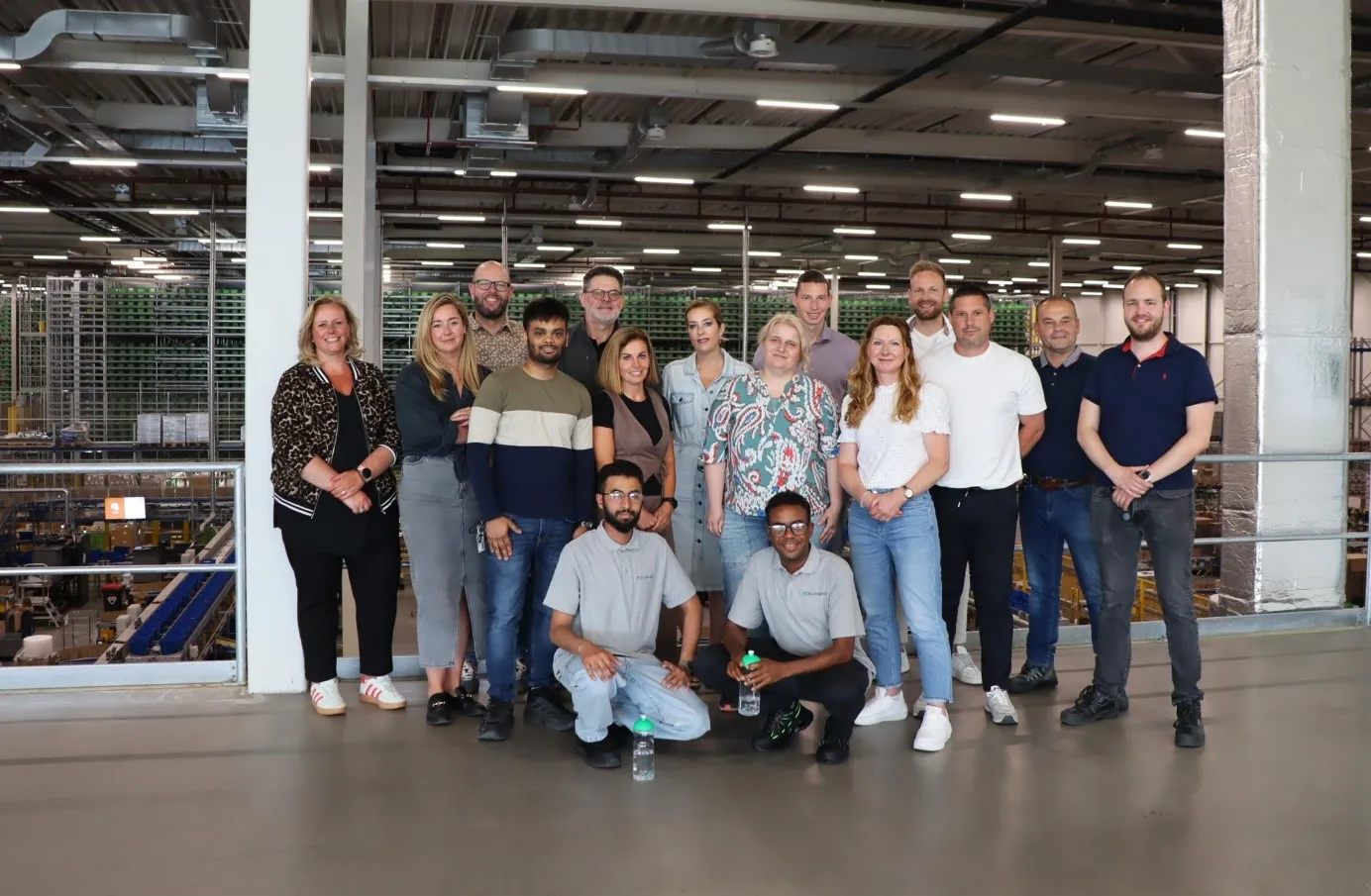People enjoying a lively street event with a rainbow flag, capturing the vibrant spirit of the day.