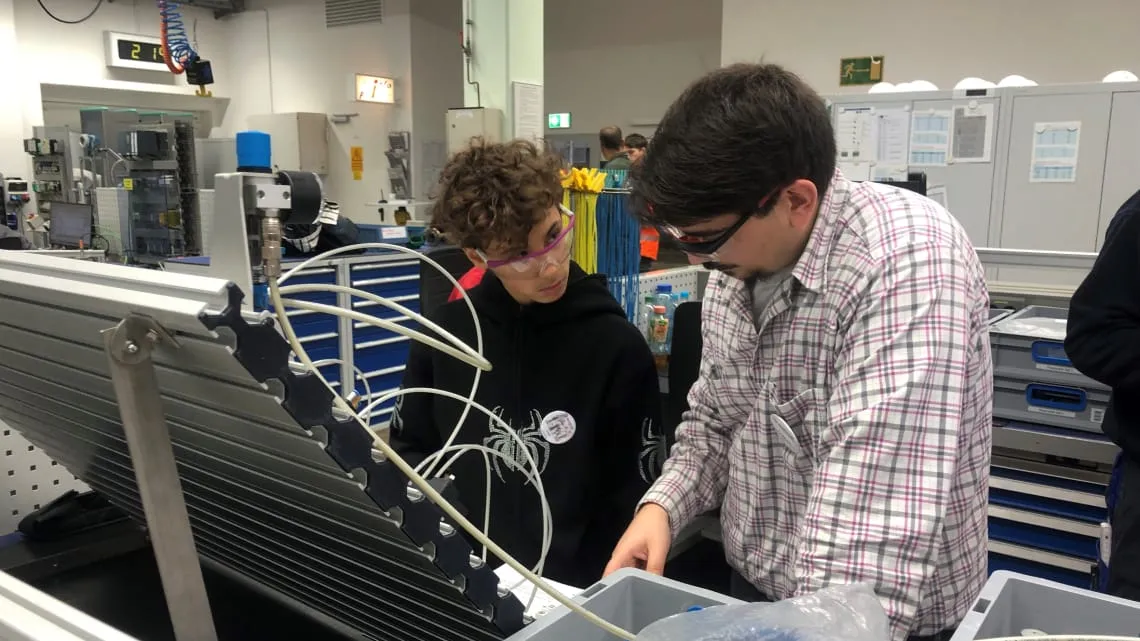 Ein Ausbilder zeigt dir in einer Werkstatt bei Evonik, wie moderne Energietechnik praktisch angewendet wird.