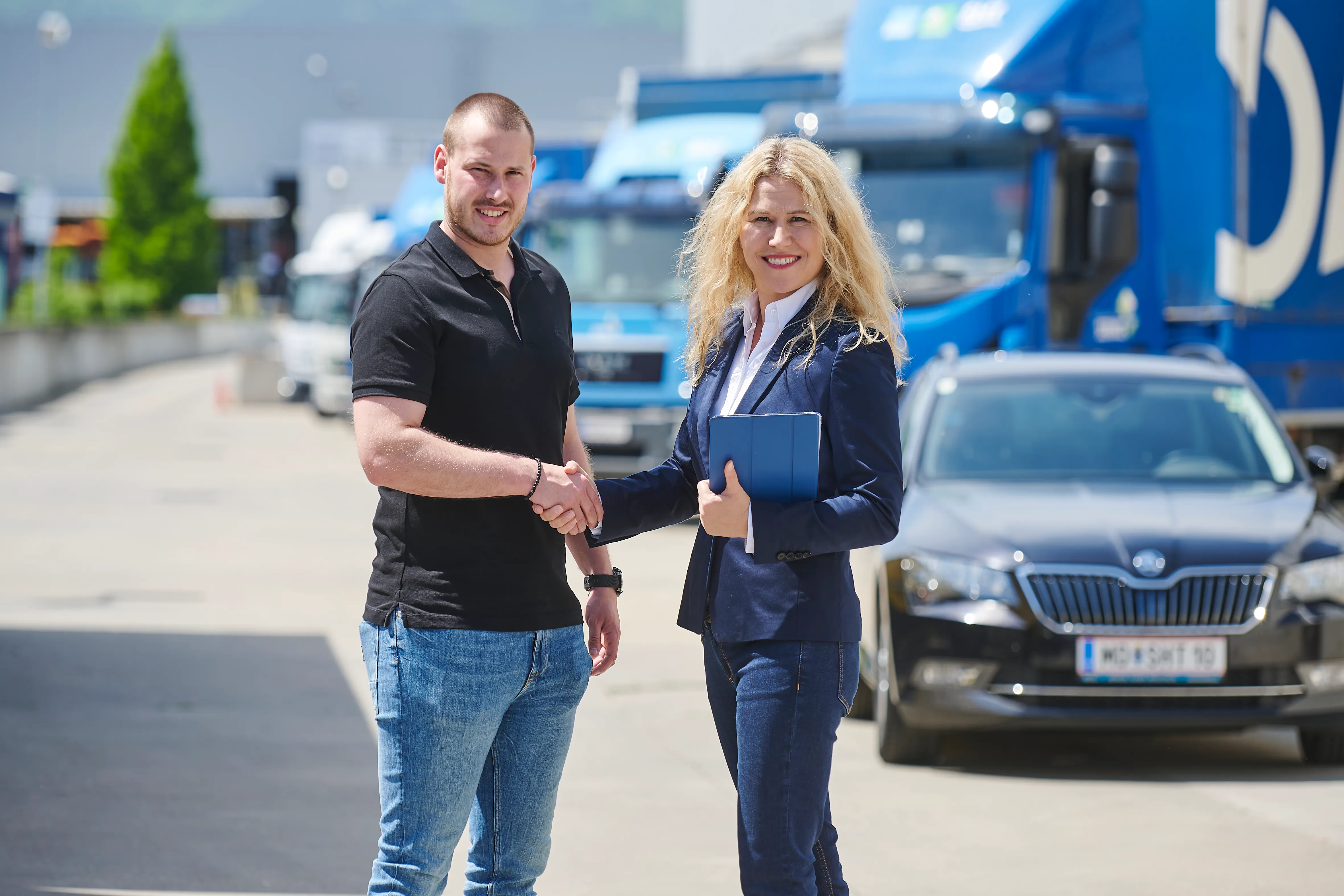 Mitarbeiter in einem Frauenthal Handel Gruppe Geschäft präsentieren ein Produkt und sind umgeben von Regalen mit Installationsbedarf.