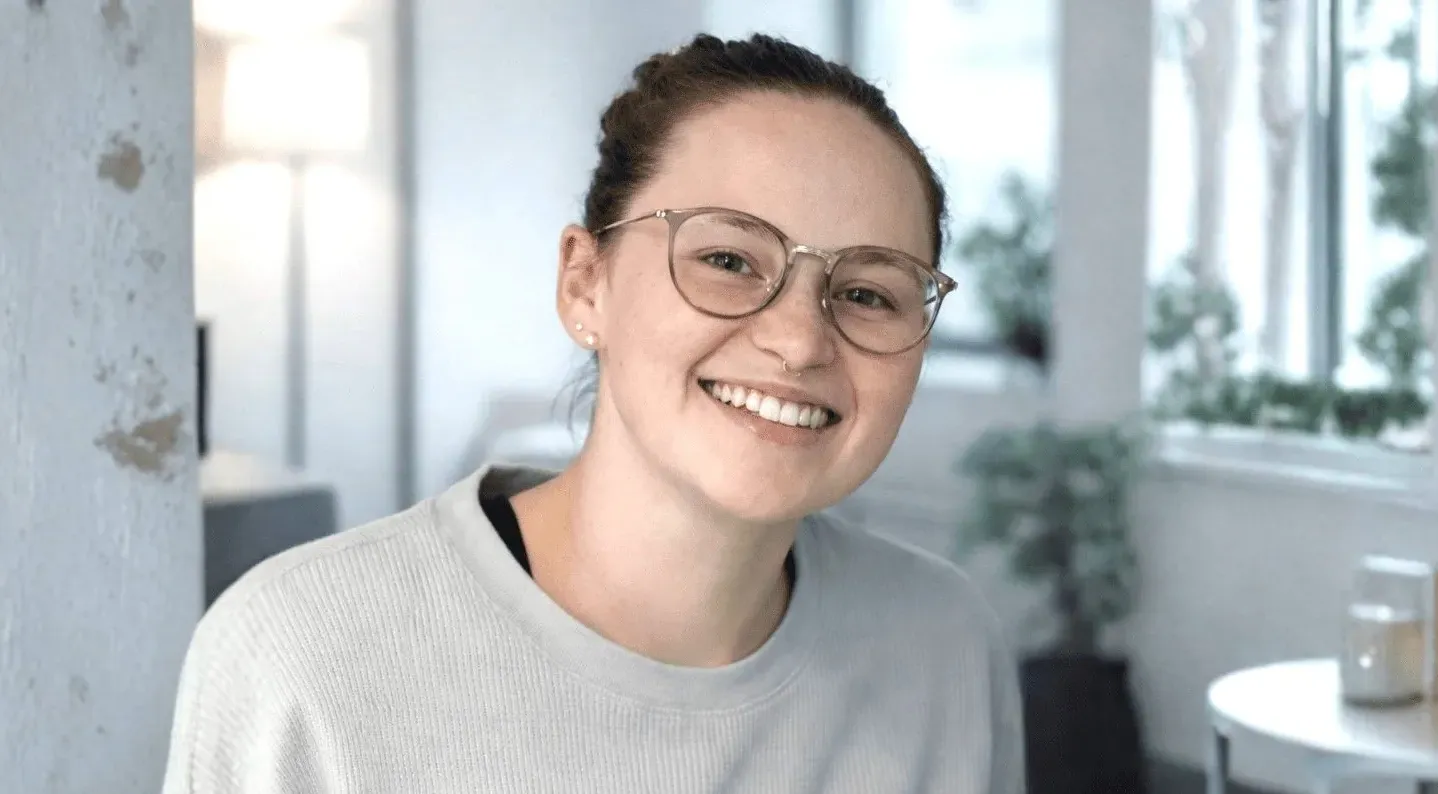 Smiling person in a cozy office space.