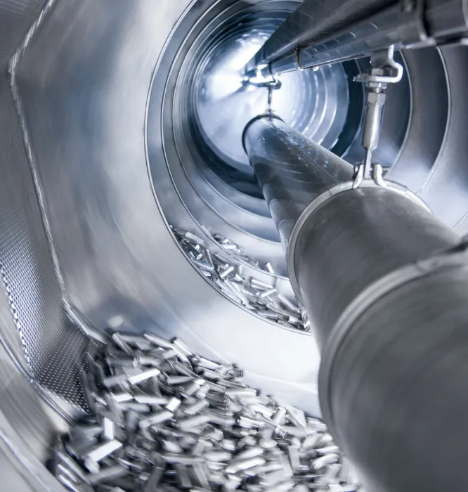 Inside view of a Heitkamp & Thumann manufacturing machine with metal parts being processed.