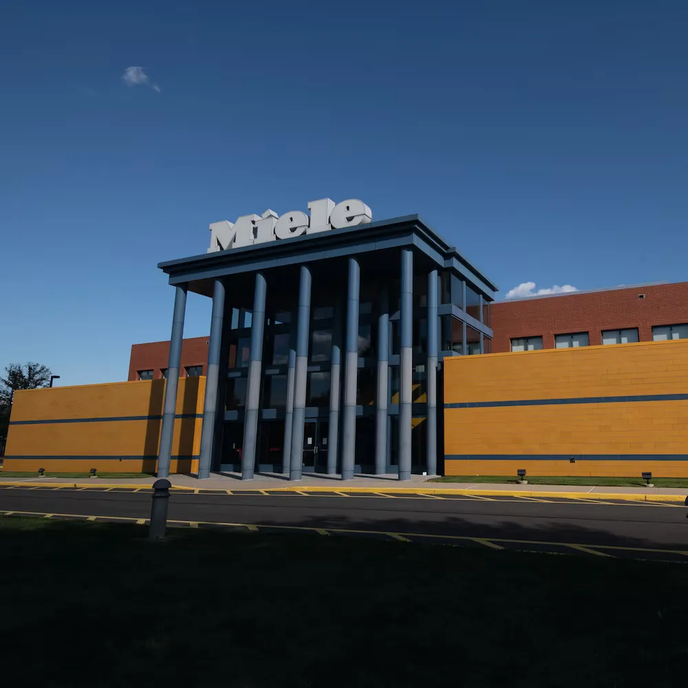 Front view of Miele's office building in America with a modern facade.