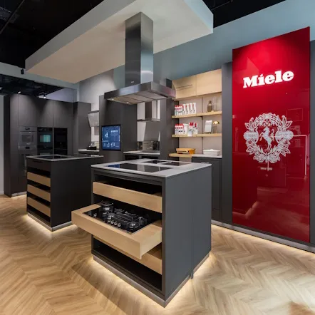 Sleek Miele kitchen showroom in Hungary displaying modern appliances and stylish cabinetry, perfect for inspiring your culinary adventures.