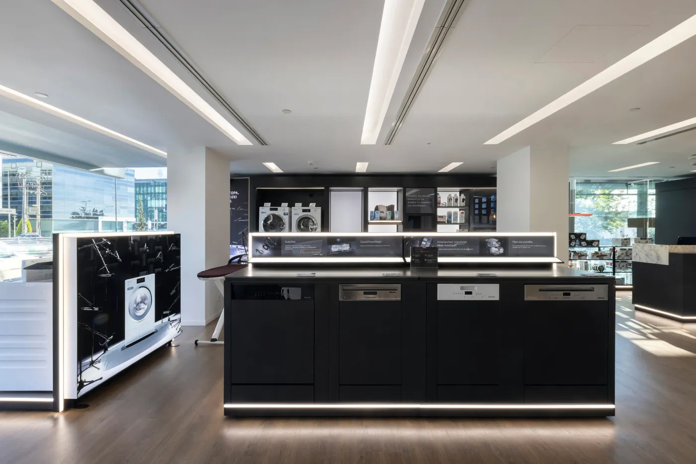 Explore Miele's sleek showroom in Greece featuring modern appliances like dishwashers and washing machines, perfect for innovation lovers.