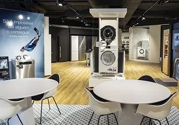 Modern showroom in Portugal featuring Miele appliances with stylish seating for casual chats and product exploration.