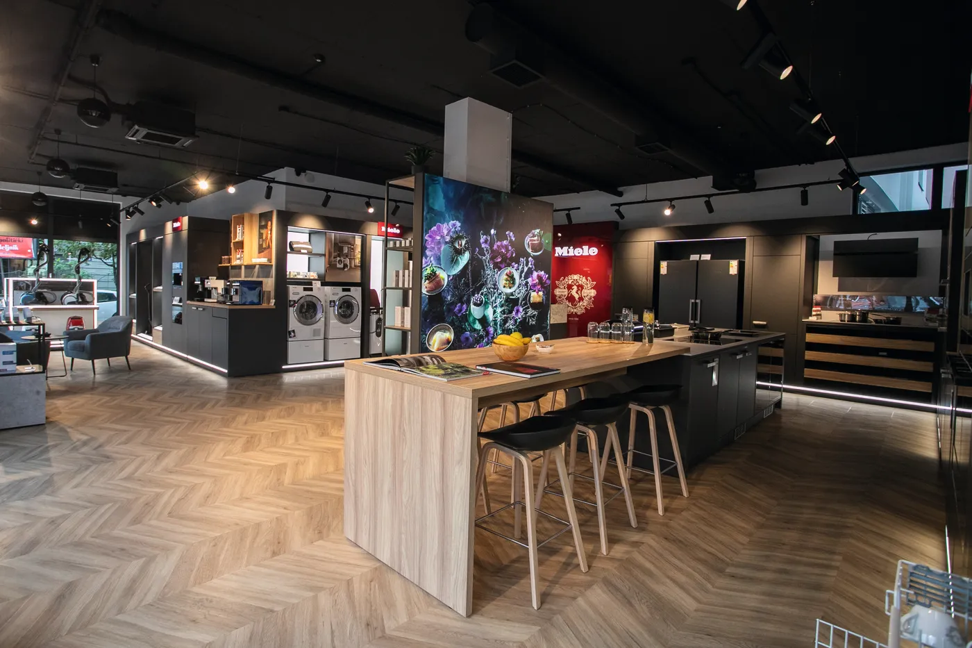 Modern Miele showroom in Serbia with sleek kitchen and laundry appliances, inviting counter space, and stylish decor. Perfect for exploring!