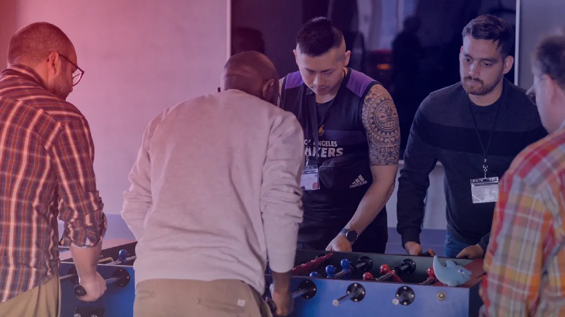 employees playing fooseball table