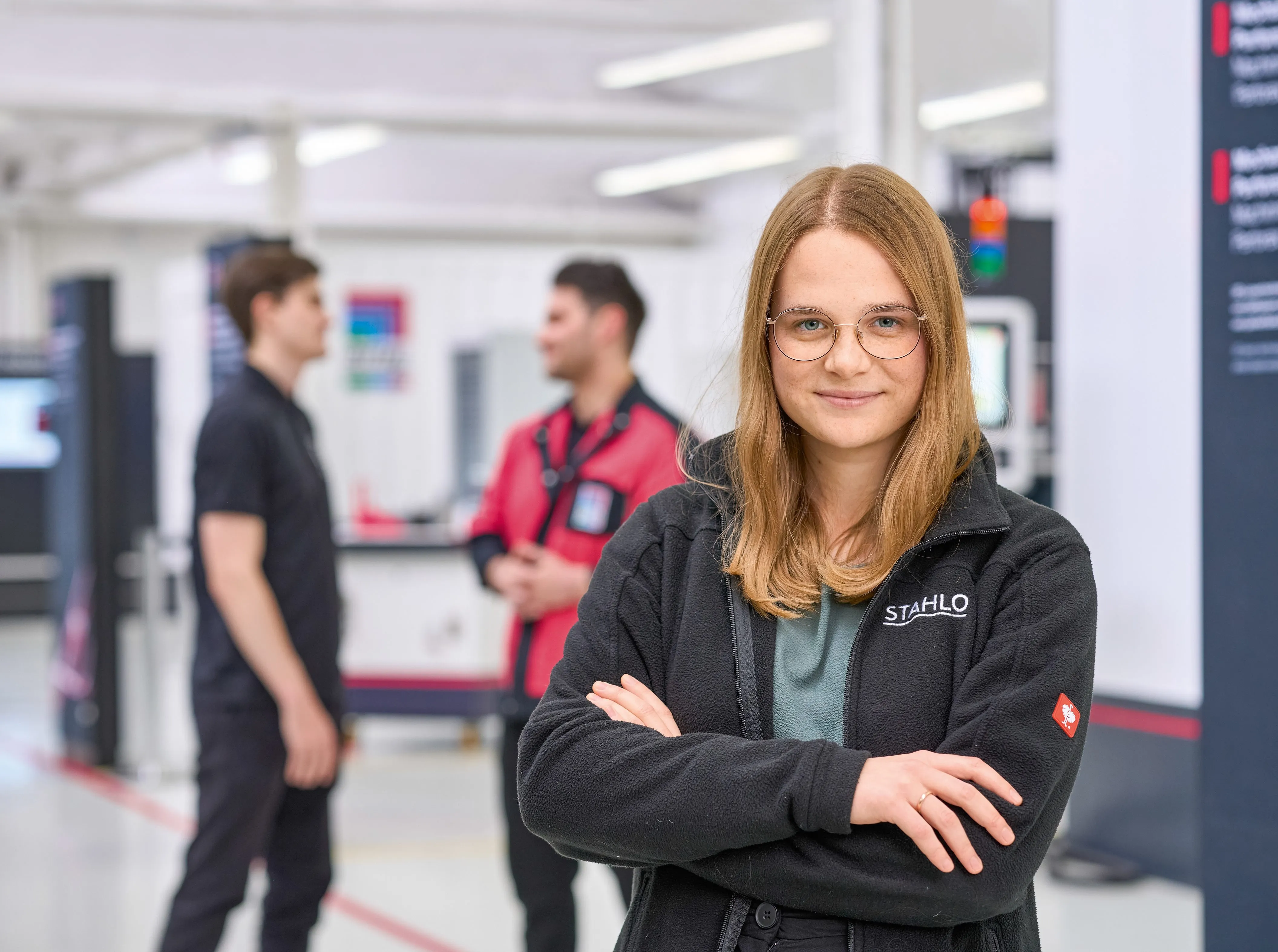 Frau lächelt mit verschränkten Armen