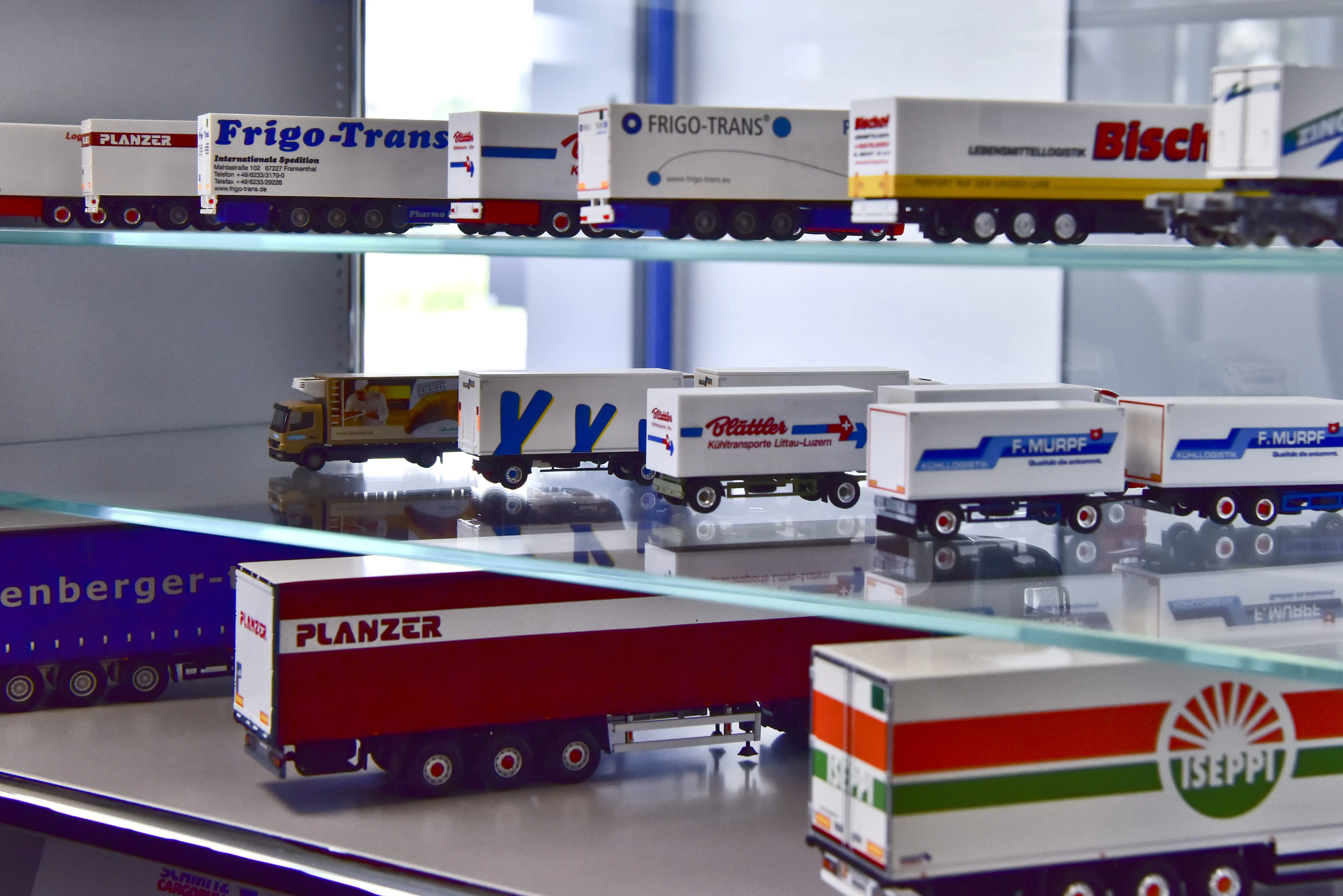 Miniature model trucks on display, showcasing Schmitz Cargobull AG’s innovative designs in the automotive industry.