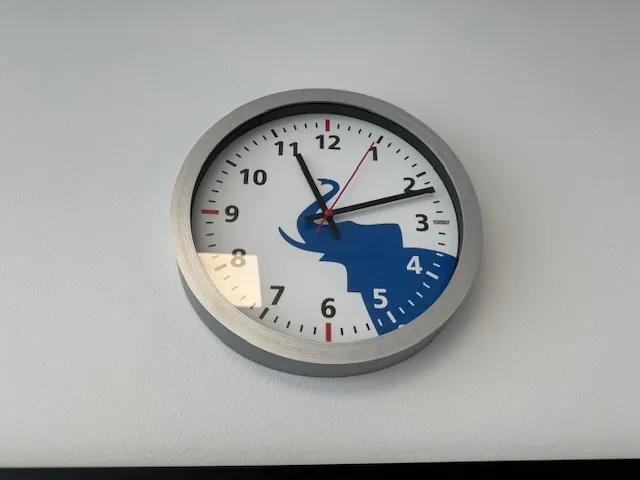 A wall clock featuring the Schmitz Cargobull logo, blending time with automotive style.