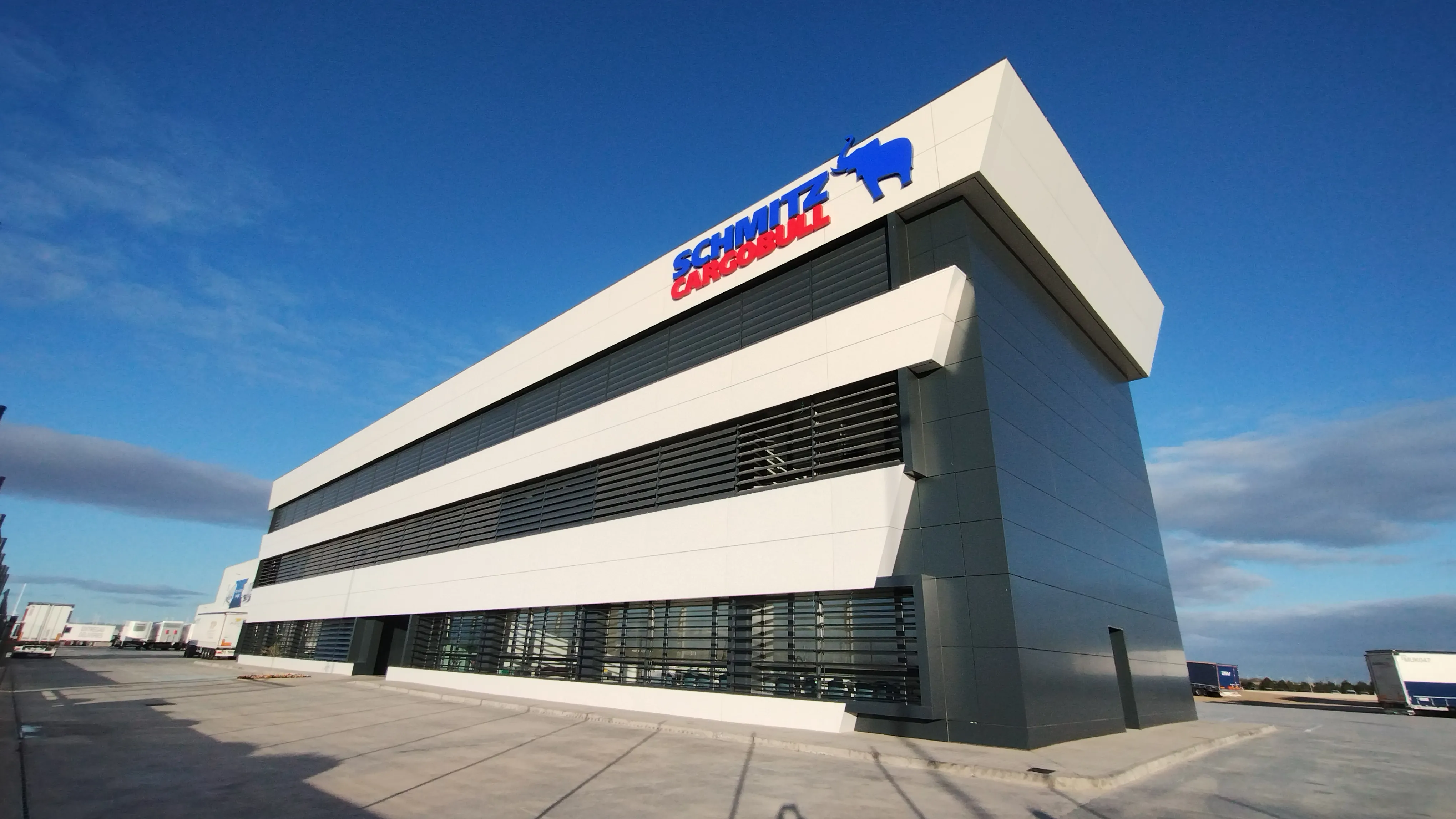 Check out Schmitz Cargobull's sleek office building under a clear blue sky. Ready to join the automotive innovation?