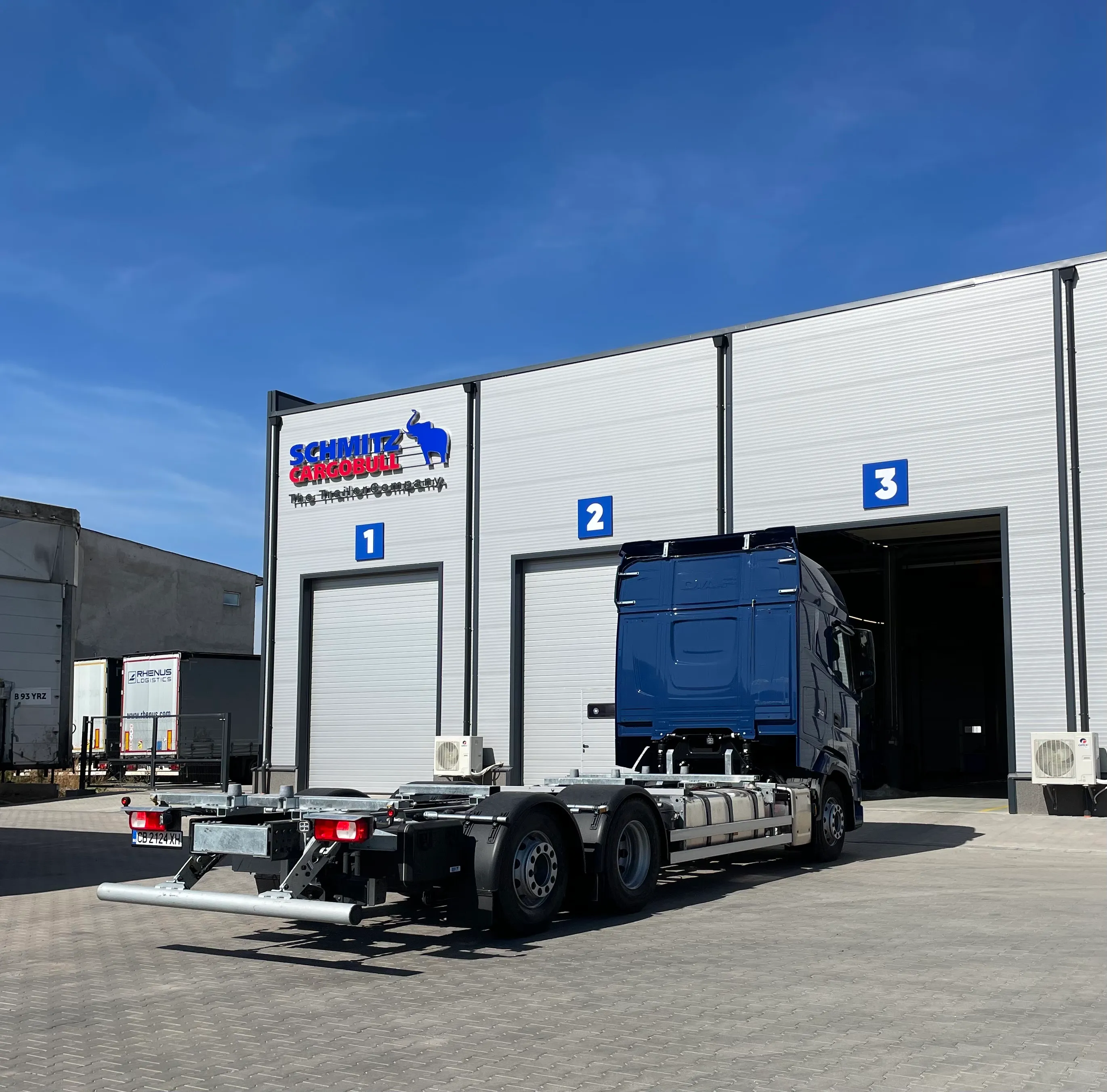 Check out the sleek blue truck outside the Schmitz Cargobull service center, ready to roll into one of the bays.