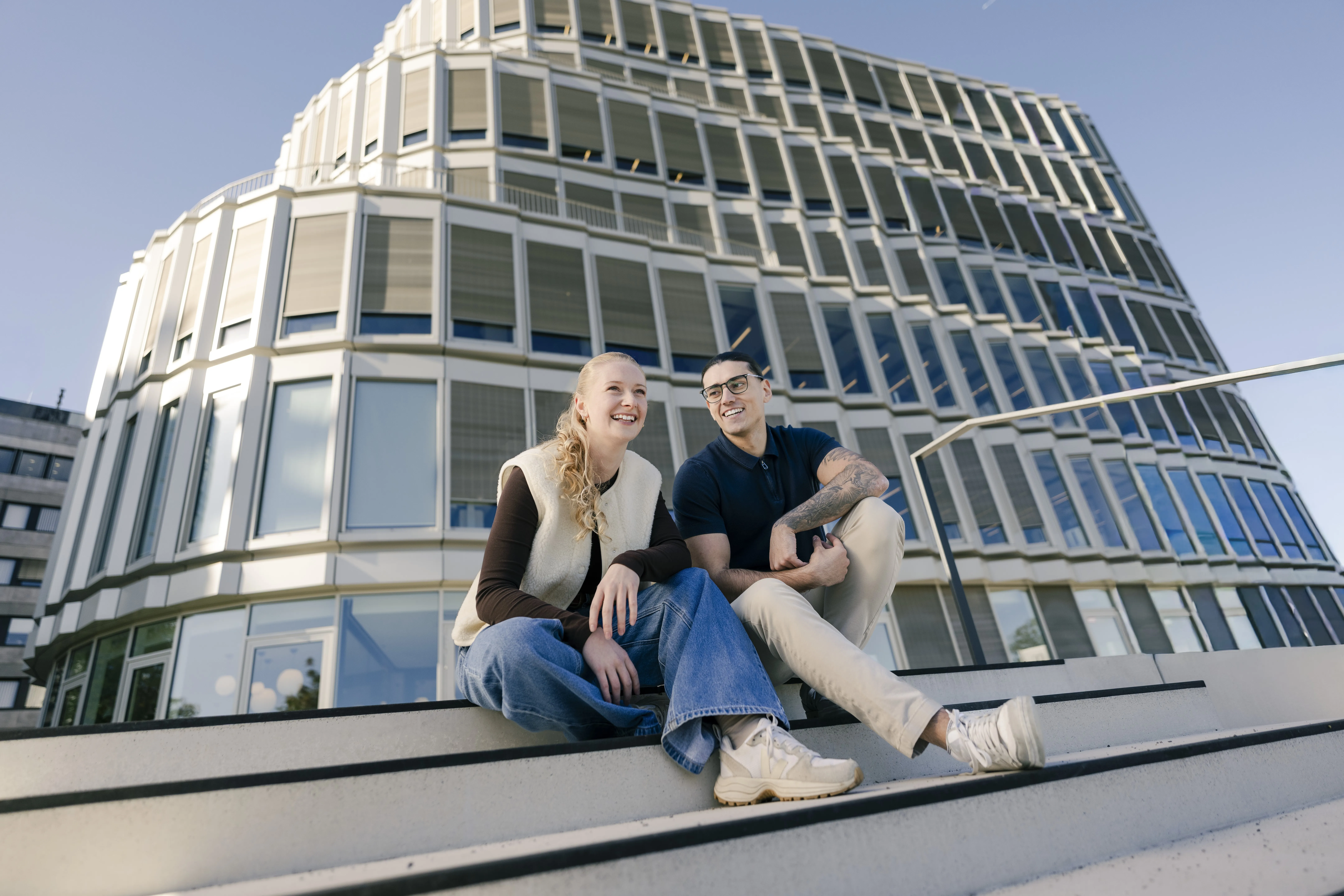 Modern office building from Schüco International KG in the sunset, with innovative design and large glass façades.