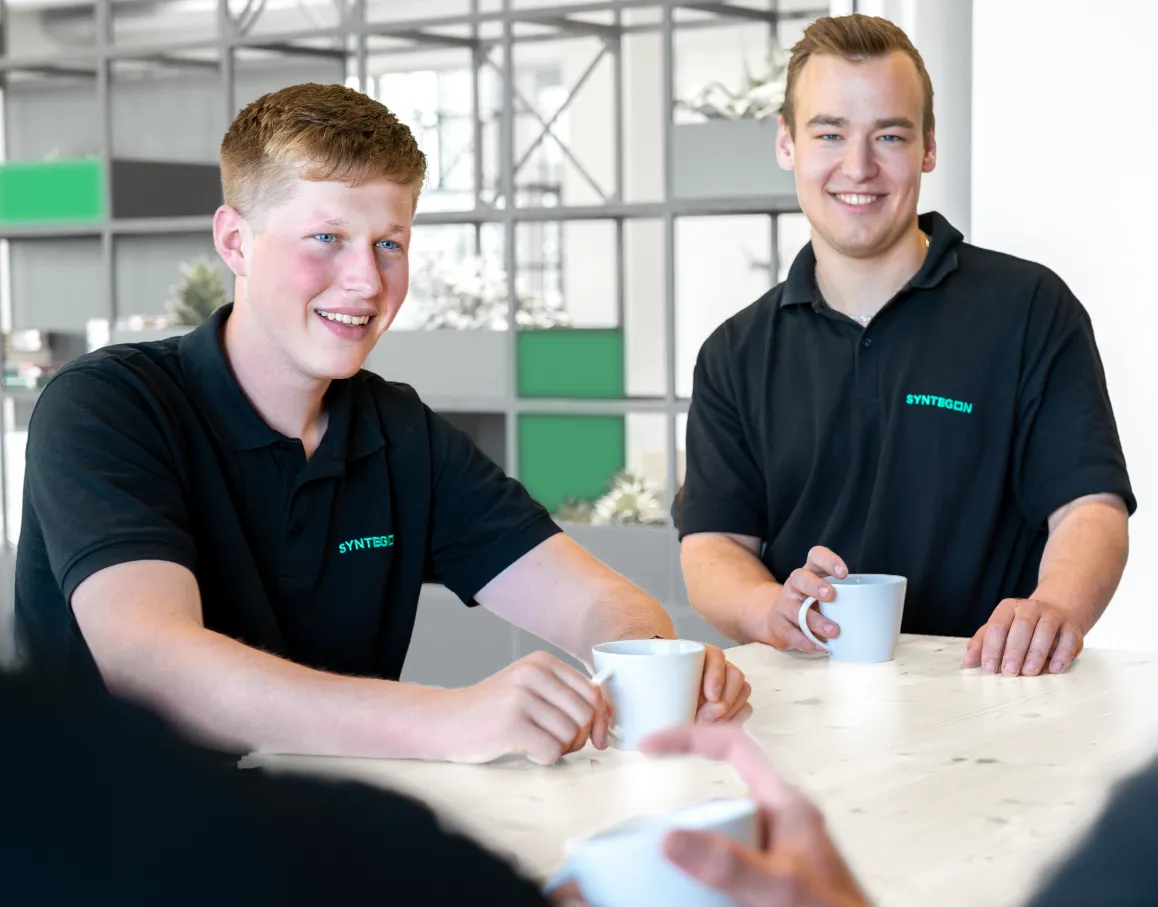 2 smiling students at a table