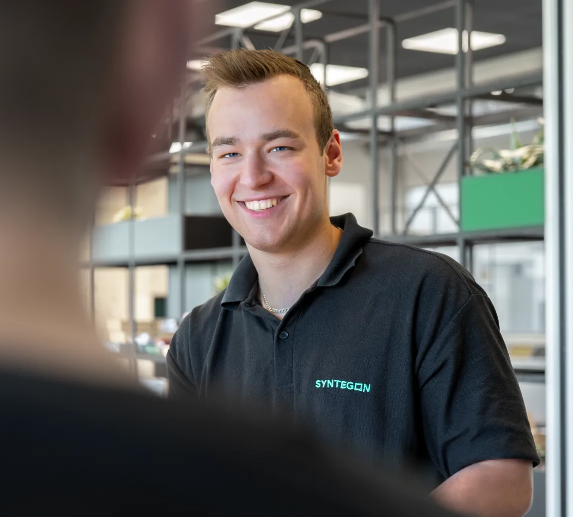 smiling student in Syntegon shirt