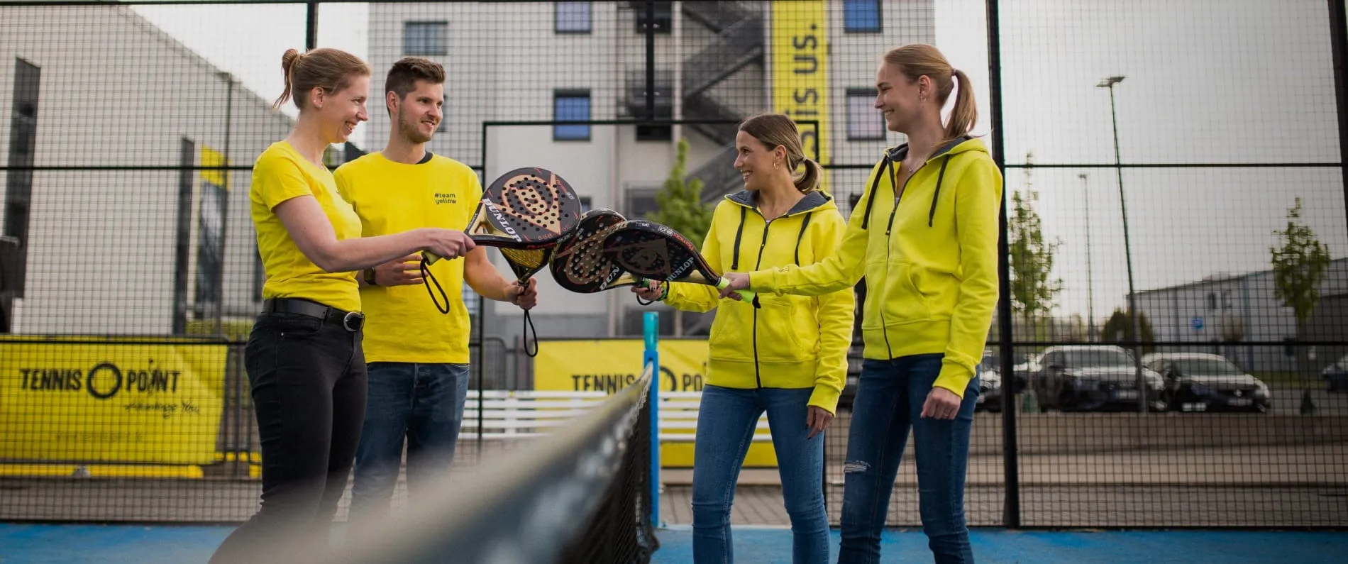 Four people on a tennis court