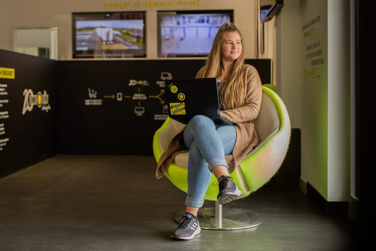 A girl with a laptop in an armchair