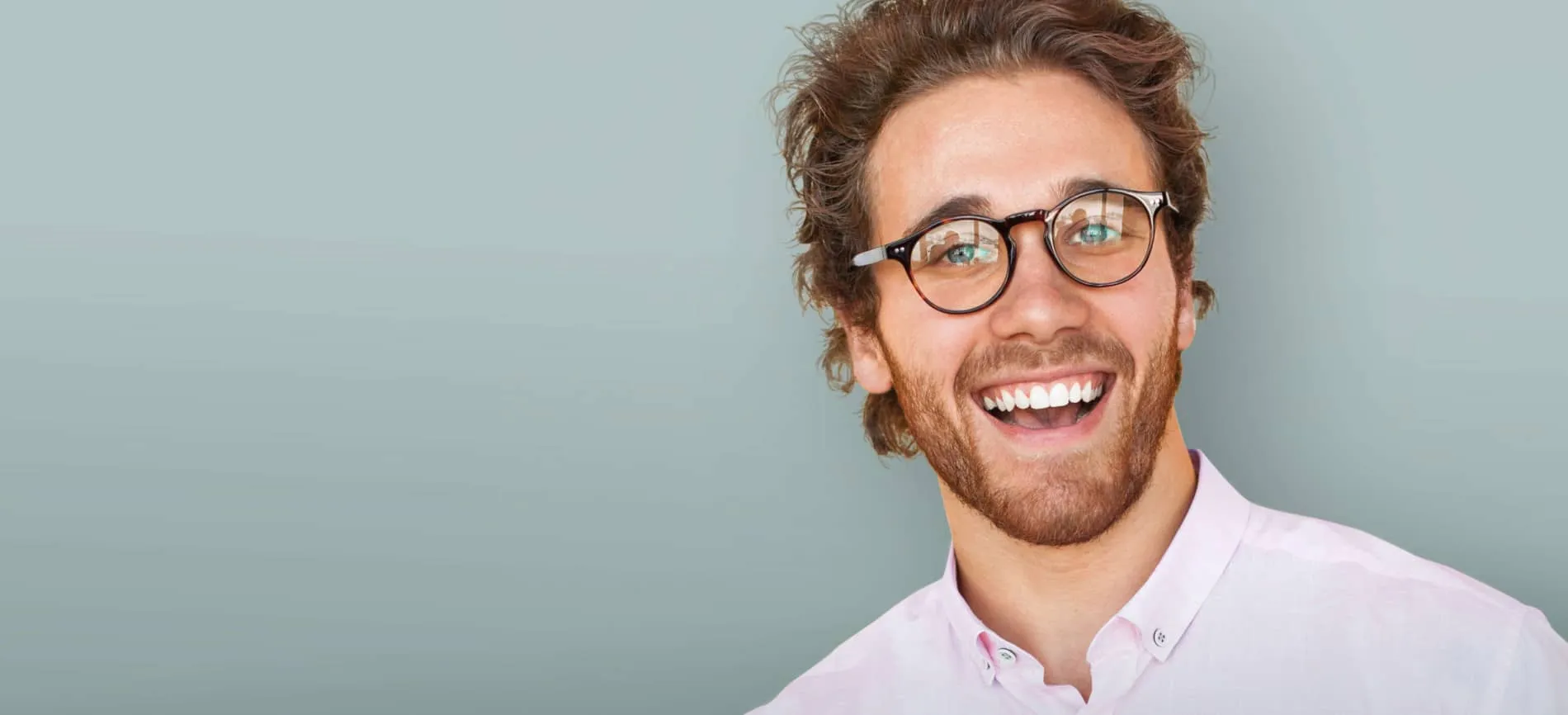 Lächelnder junger Mann mit Brille und Hemd, der dich auf der Karriereseite von Westfalen Weser Netz begrüßt.